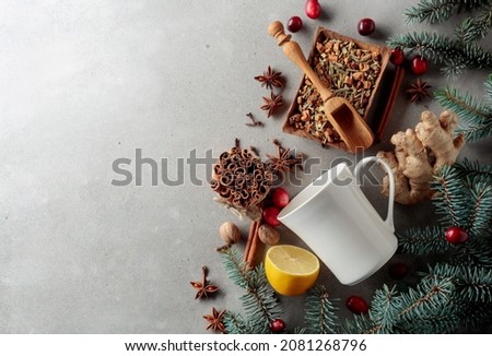 White mug and ingredients for making a winter hot drink on a grey concrete background. Top view. Copy space.