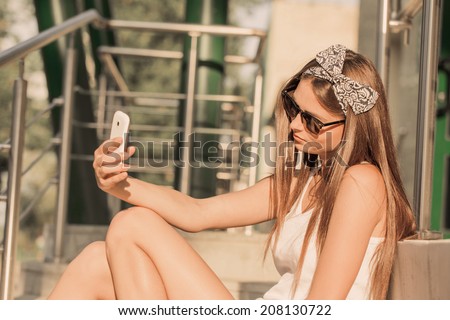 girl  taking photos with a telephone