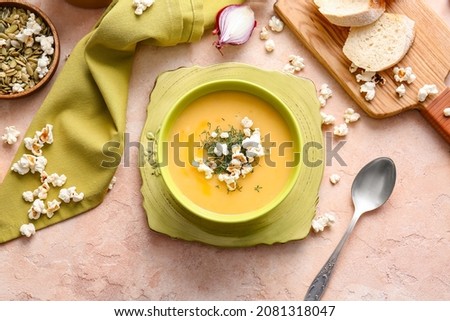Bowl with tasty popcorn soup on table