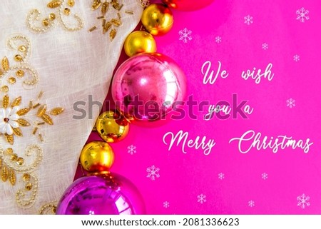 Christmas balls and ornaments on a pink background 