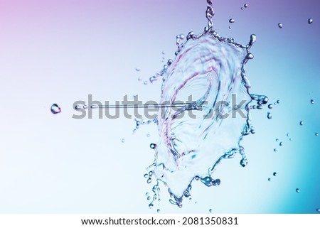 Clear water liquid splash on a blue background