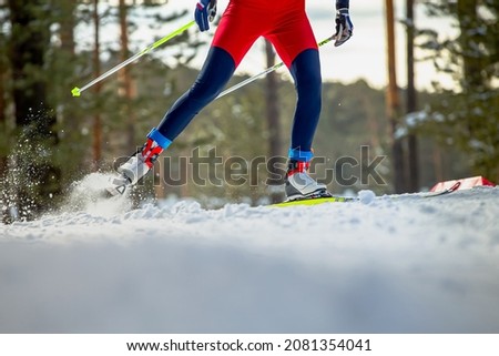 male skier athlete goes uphill on cross-country skiing Royalty-Free Stock Photo #2081354041