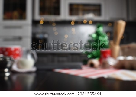 Blurry Christmas kitchen background for design. The kitchen is unfocused and decorated for the new year.