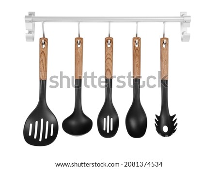 Metal rack with set of kitchen utensils on white background Royalty-Free Stock Photo #2081374534