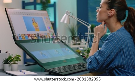 Woman photographer doing retouch work on touch screen while designing gradient for pictures. Media artist working with retouching software to edit photos in photography studio. Professional editor