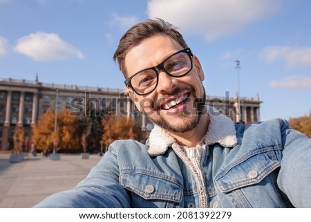Handsome man taking selfie outdoors