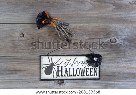Top view of Halloween sign with scary hand on rustic wood