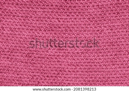 Pacific pink knitted fabric texture. Rough sweater background