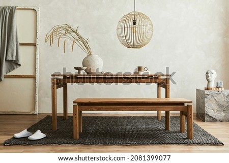 Creative composition of elegant dining room interior design with wooden family table, bench and beautiful home decorations and accessories. Modern home concept. Wabi-sabi inspiration. Template. Royalty-Free Stock Photo #2081399077