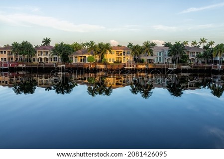 Hollywood beach in north Miami, Florida with Intracoastal water canal Stranahan river and view of waterfront property modern mansions villas houses with palm trees reflection at sunset Royalty-Free Stock Photo #2081426095