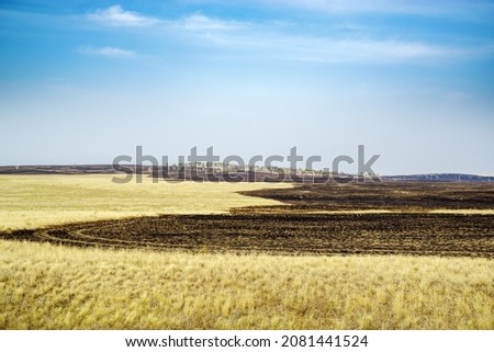 Steppe landscape at the end of summer, after a fire. The picture was taken in Russia, in the Chelyabinsk region