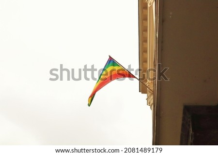 Bright flag of the LGBT community on the house 
