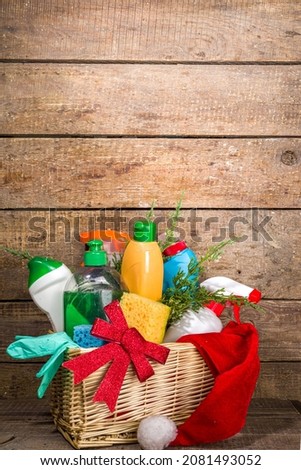  Christmas cleaning concept. Various bottles, equipment, and accessories, gloves for cleaning with christmas decor and santa hat. Cleaning service advertising mockup background