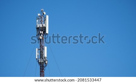 Technology on the top of the telecommunication GSM 5G, 4G, 3G tower.Cellular phone antennas on a building roof.silhouette of Telecommunication mast television antennas. Royalty-Free Stock Photo #2081533447
