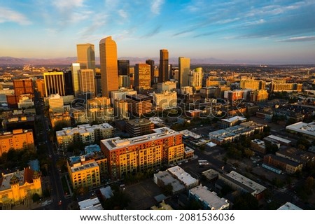 perfect orange sunrise over Denver Colorado USA gorgeous golden hour sunlight hits skyline cityscape of the mile high city 