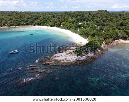 Generic aerial picture of beautiful rocky white sand beach with turquoise sea green water and lush green forest in the mainland. Ao Wai beach, Koh Samet Island, Thailand