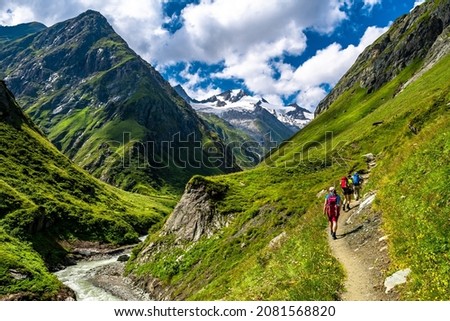 Hiking Group In Valley Of Umbalfaelle On Grossvenediger With View To Mountain Roetspitze In Nationalpark Hohe Tauern In Tirol In Austria Royalty-Free Stock Photo #2081568820