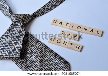 national tie month text on wood, isolated at white background