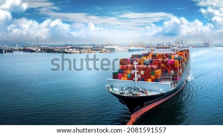 Aerial side view of cargo ship carrying container and running for export  goods  from  cargo yard port to custom ocean concept technology transportation , customs clearance. Royalty-Free Stock Photo #2081591557