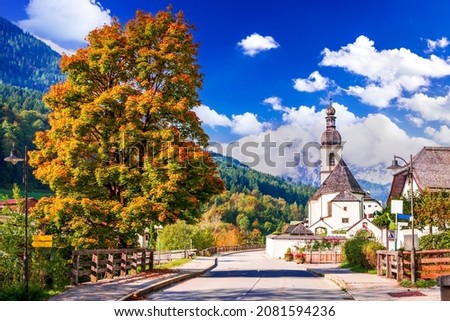 Ramsau bei Berchtesgaden, Germany. Autumnal scenery Berchtesgadener Land in Bavaria with incredible seasonal view of Parish Church of St. Sebastian and River Ramsauer Ache. Royalty-Free Stock Photo #2081594236
