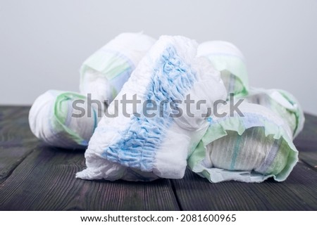 Diapers waste, dirty diapers. Disposing of used baby nappies. Environmental Impact of Disposable Diapers. Pollution of the environment, soil and water