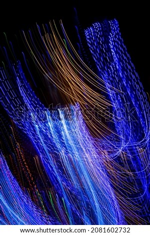 Abstract blurred light effect on a black background. Long exposure photo of moving the camera.