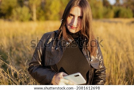 serious woman with smart phone outdoors