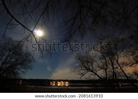 Autumn night photo. Great nature at the Swedish countryside. Shiny moon and some clouds. Long exposure shot. Stockholm, Sweden, Scandinavia, Europe.
