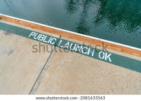 Public launch ok painted sign on a concrete dock in Oceanside, California