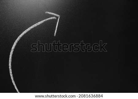 show direction curved arrow on blackboard background