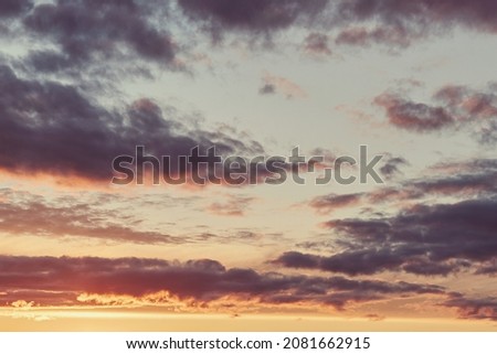 Abstract background of a dramatic sky. Clouds at sunset. Blue and orange sky