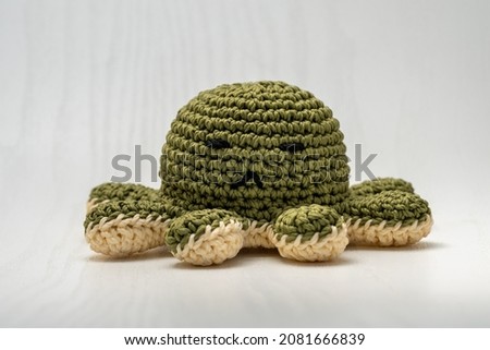 Cute green stuffed octopus doll knitted from wool