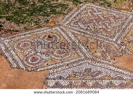 Mosaics fragment in Hadrian's Library, Athens, Greece. Beautiful patterned ornament floor in old ruins background. Archeology and history concept