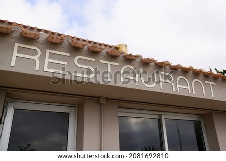 restaurant text sign on facade building city street storefront