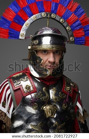 Roman centurion dressed in iron armor and colorful plumed helmet