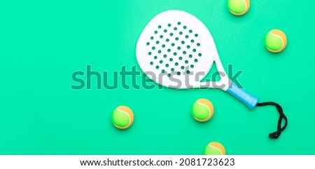 White professional paddle tennis racket and balls on mint color background. Horizontal sport theme poster, greeting cards, headers, website and app Royalty-Free Stock Photo #2081723623