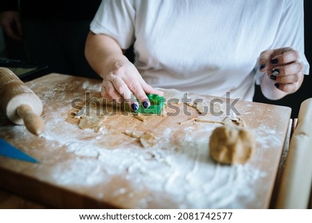 Women's hands making gingerbread christmas cookies 
