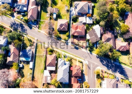 Aerial top down view in residential suburb of city of Ryde in Greater Sydney on a sunny day - quiet green streets with wealthy houses. Royalty-Free Stock Photo #2081757229