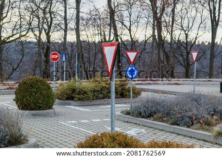 An area with road signs for learning the rules of the road. Soft focus.
