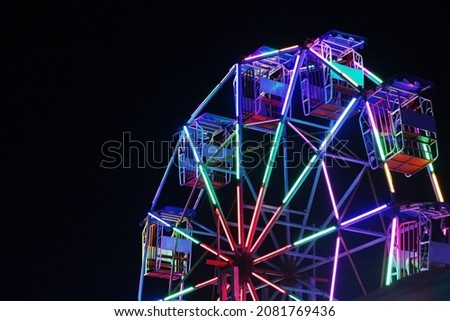Beautiful of ferris wheel at temple fair night Royalty-Free Stock Photo #2081769436