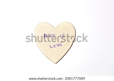 Wooden heart with love and art message on white background