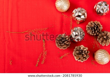 Several Christmas tree ornaments on a red cloth