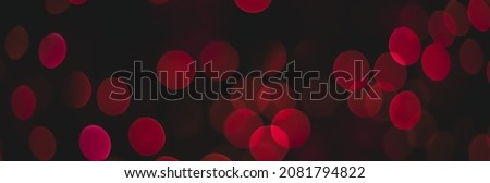 panoramic simple background wallpaper concept picture with pink bokeh circles from festive garland lamps light on black space