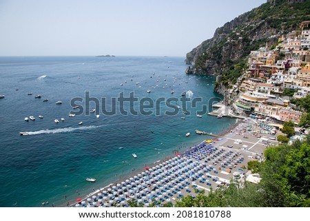 The main beach in Positano,  with its bright  umbrellas and the sparkling blue sea of the Amalfi Coast.