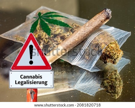 Cannabis legalization sign with joint and weed in german Royalty-Free Stock Photo #2081820718