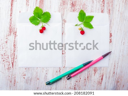 Blank picture frame paper with strawberry on wooden table