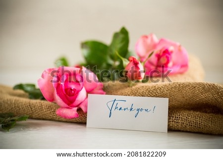 pink beautiful summer roses on wooden table