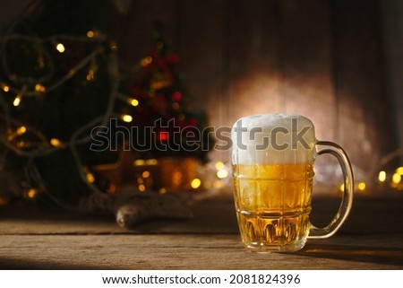 Beer in mug on wooden table with Christmas lighting background