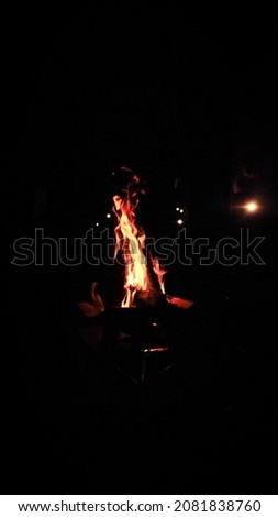 Camp fire burning in the night Royalty-Free Stock Photo #2081838760
