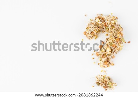 alfalfa and clover sprouts, wheat bean and lentil sprouts in the shape of the question. Organic grains good for salads and breads. Raw, vegan, vegetarian healthy food concept. Healthy diet and vegeta Royalty-Free Stock Photo #2081862244